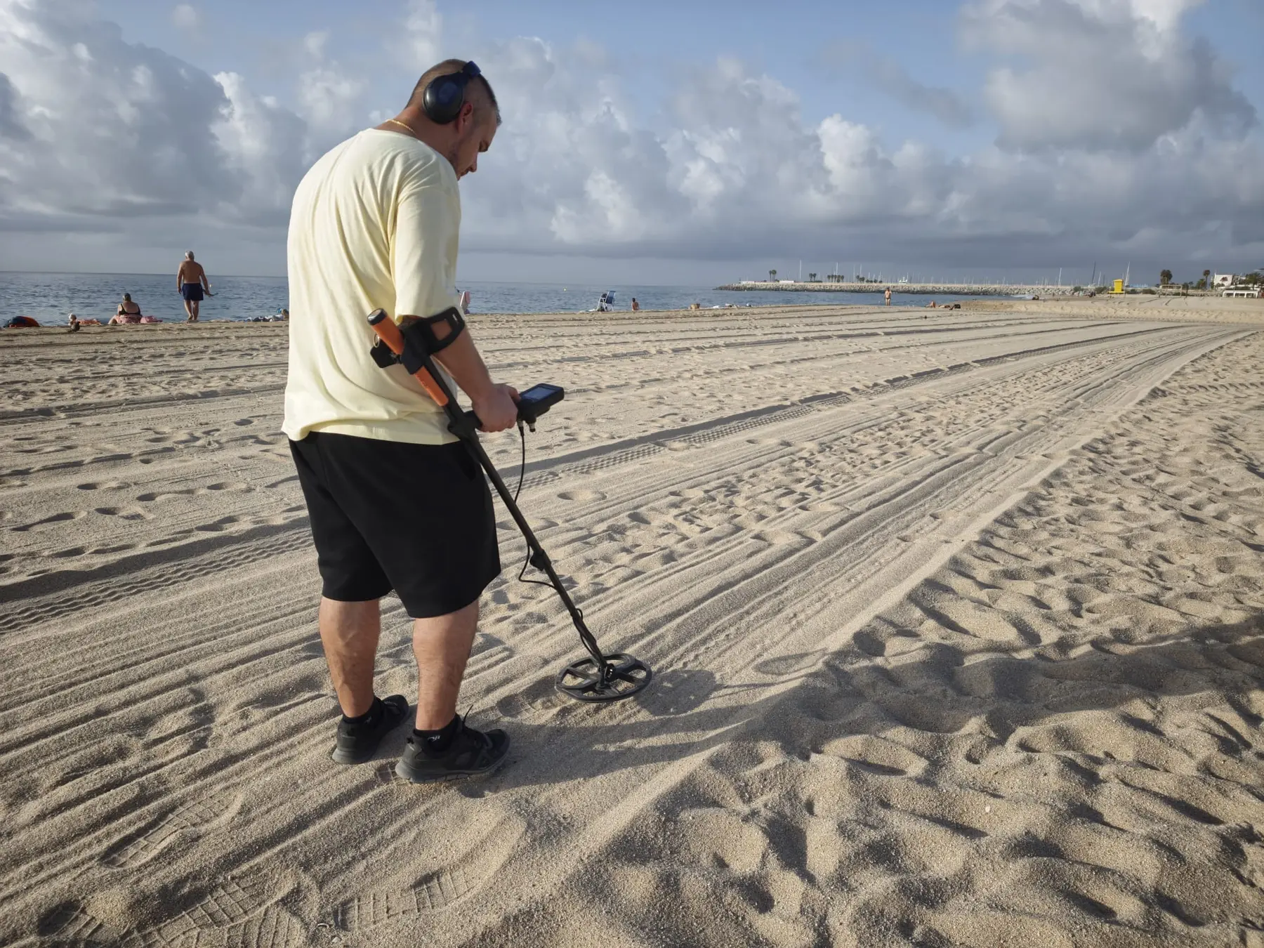 Professional metal detector search on a Barcelona beach